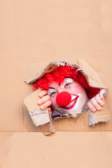 Funny kid clown with red nose playing