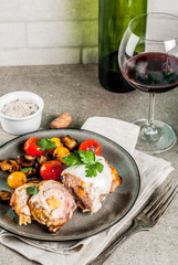 Homemade meat cutlet cordon bleu, grey stone background copy space