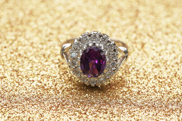 purple gemstone on diamond ring