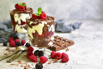 No baked brownie cheesecake with fresh berries in a glass.