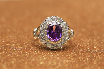 purple gemstone on diamond ring