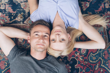 Young couple relaxing on a Persian carpet
