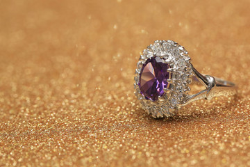 purple gemstone on diamond ring