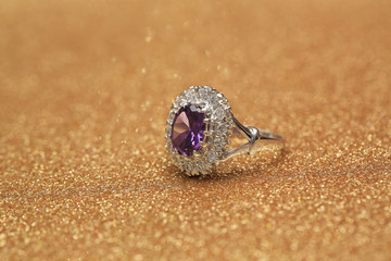 purple gemstone on diamond ring