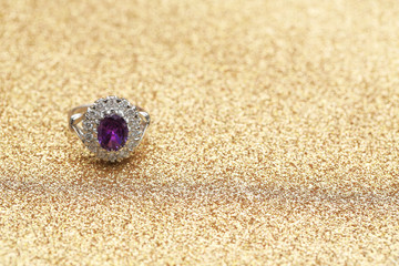 purple gemstone on diamond ring