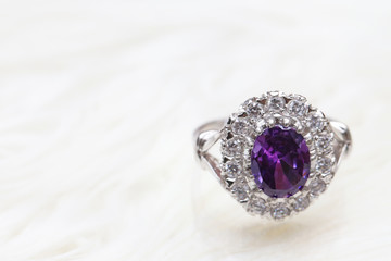 purple gemstone on diamond ring