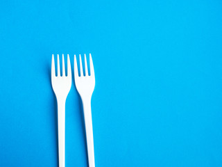 Plastic fork pattern on blue background