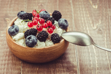 cottage cheese with berries/healthy breakfast: bowl of cottage cheese with fresh berries. selective focus