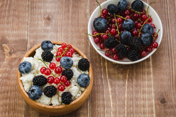 cottage cheese with berries/healthy breakfast: bowl of cottage cheese with fresh berries. Top view