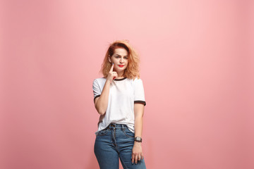 Let me think. Doubtful pensive woman with thoughtful expression making choice against pink background