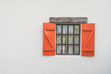 Close up traditional or vintage opened wooden window on white concrete wall. (Selective focus)
