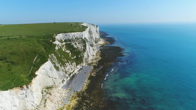 Aerial view of famous white cliffs of Dover, clear blue sky - English Channel, England, Great Britain from above, 4k UHD