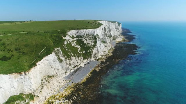 Aerial view of famous white cliffs of Dover, clear blue sky - English Channel, England, Great Britain from above, 4k UHD