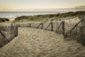 Aged looking image with wooden fence and Atlantic ocean early morning