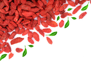 Dried goji berries decorated with green leaves Isolated on white background with copy space for your text