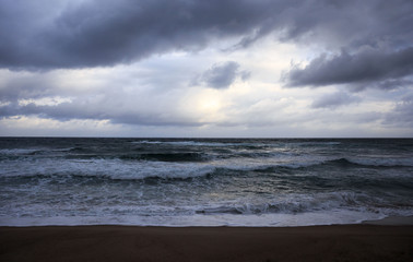 Sun shines through dark clouds in the early morning