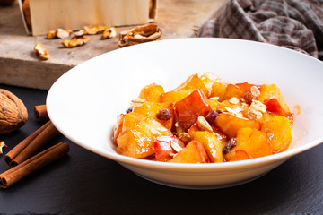 food concept Fried Red organic Apple chopped with cinnamon,sugar and butter in the white dish