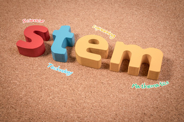 STEM Education. Science Technology Engineering Mathematics. STEM word on cork board with education equipments for background.