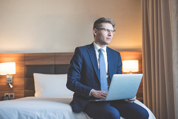 Young businessman with laptop in the hotel