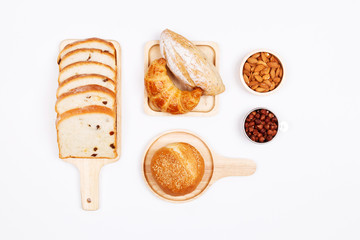Homemade breads or bun, bakery ingredients, flour, eggs almond nuts, hazelnuts on white background, , Bakery background frame, Cooking breakfast concept. Flat lay, Top view.