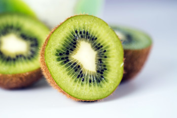 Ripe whole kiwi fruit and half kiwi fruit on white background