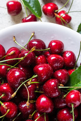 Fresh red ripe cherries on white plate