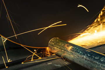 the worker cutting steel with an industrial fiber cutter.
