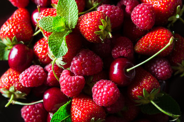 Fresh red ripe berries on black plate