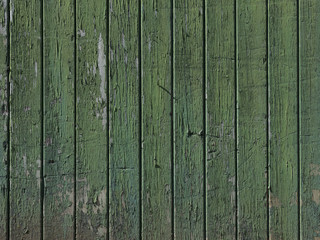 part of old worn down grungy green painted barn door with vertical planks