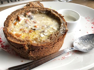 Mushrooms soup in a bread bowl