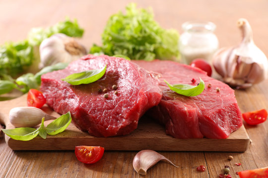 raw meat fillet and basil