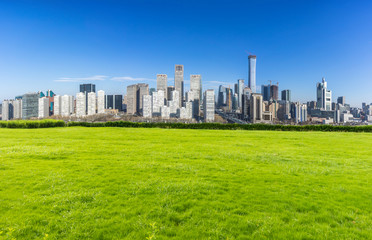 Fototapeta na wymiar green lawn with beijing cityskyline