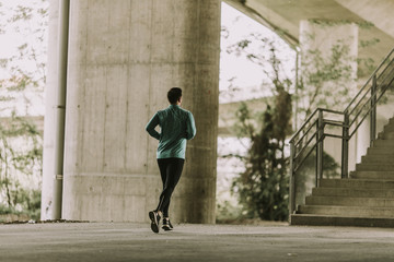 Young man running in urban enviroment