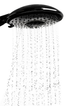Water drops from shower head in bathroom on white background,stop motion