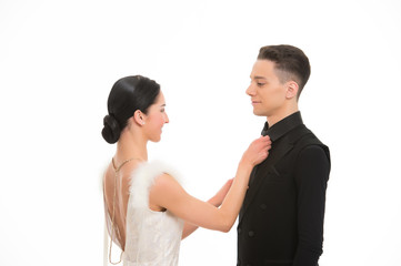 Sensual woman fix tie to man. Bride in white dress and groom in tuxedo. Couple of ballroom dancers in love. Wedding and proposal or love date concept. Valentines day celebration