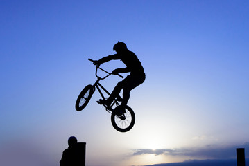 Bicycle rider making a bike jump.