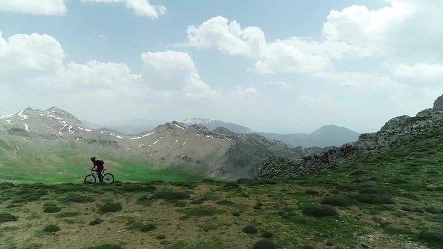 crazy man cycling on tough mountain trails