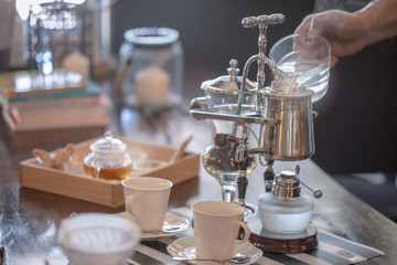 close up of siphon vacuum, coffee cup and siphon vacuum coffee maker at shop