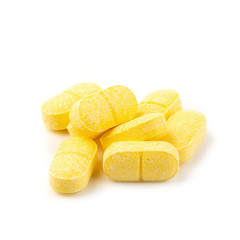 Vitamin C, yellow vitamin pills isolated on white background.
