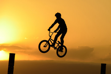 Fototapeta na wymiar Bicycle rider making a bike jump.