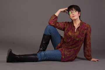 Elegant middle aged woman posing in studio