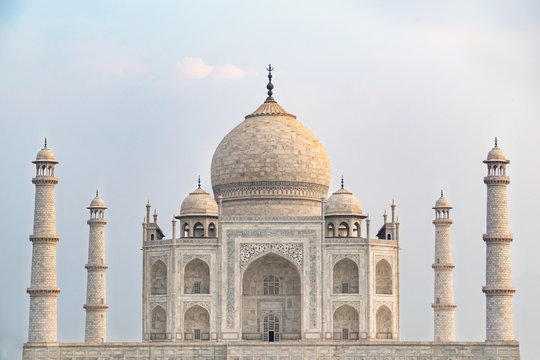 Taj Mahal front view reflected on the reflection pool, an ivory-white marble mausoleum on the south bank of the Yamuna river in Agra, Uttar Pradesh, India. One of the seven wonders of the world.