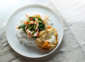 Kao Pad Kra Prao or Thai rice with squid and basil.Thai style food, Egg fried rice close