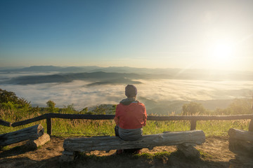 Man sitting and looking the spectacular view of Doi Samur Dao in Nan province of Thailand in winter season.