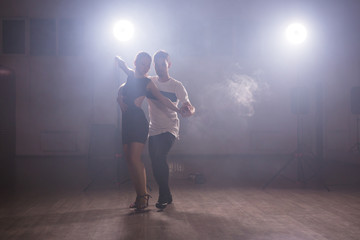 Young couple dancing latin dance Bachata, merengue, salsa. Two elegance pose in dance class