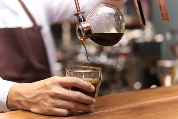 Hand drip siphon coffee, Barista pouring brewed coffee in the cup.Step by step cooking instructions