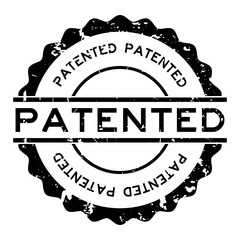 Grunge black patented word round rubber seal stamp on white background