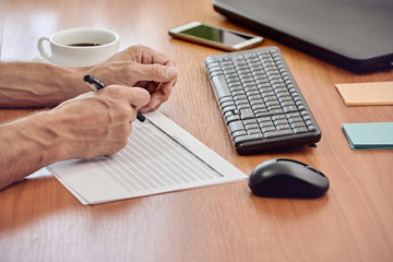 Closeup photo of businessman working with documents in modern office