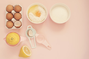 Ingredients and kitchen bake tools for cooking lemon cake or sweets - eggs, flour, sugar, hand...