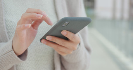 Woman sending sms on mobile phone